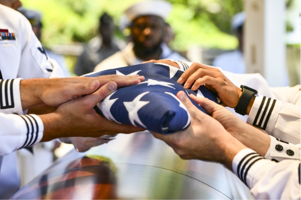 hands holding folded flag - memorial day post